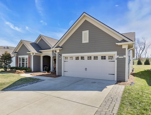 view of front facade with a garage, concrete driveway, a shingled roof, and a front yard