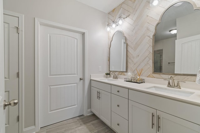 bathroom featuring double vanity, tasteful backsplash, a sink, and wood finished floors