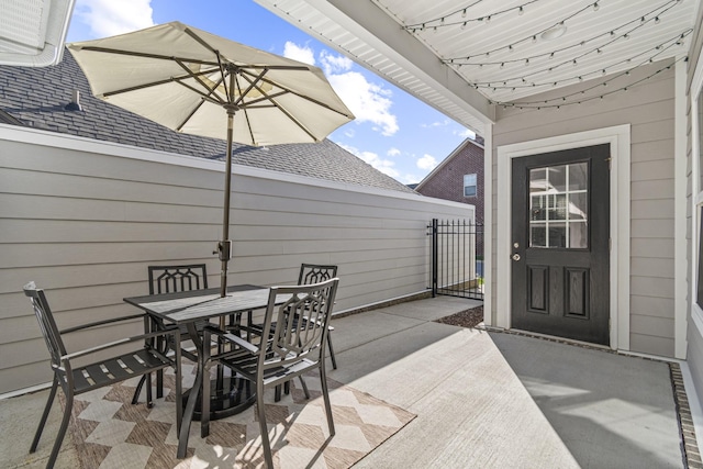 view of patio / terrace featuring a gate, fence, and outdoor dining area