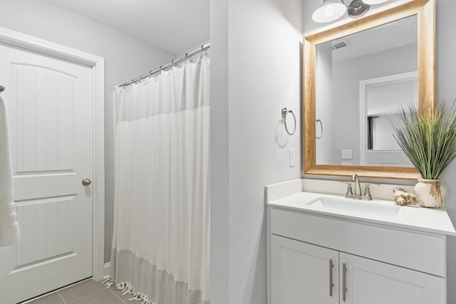 bathroom with a shower with curtain, visible vents, vanity, and tile patterned floors