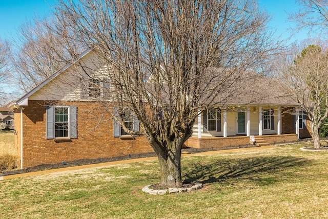 view of property exterior featuring brick siding and a lawn