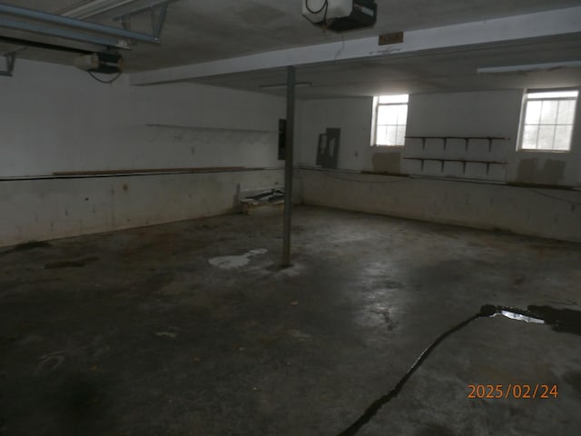 parking garage featuring electric panel and a garage door opener