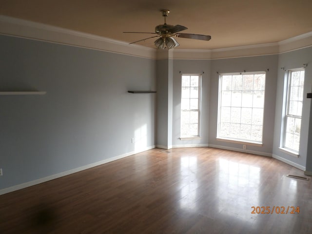 spare room featuring baseboards, light wood finished floors, and crown molding