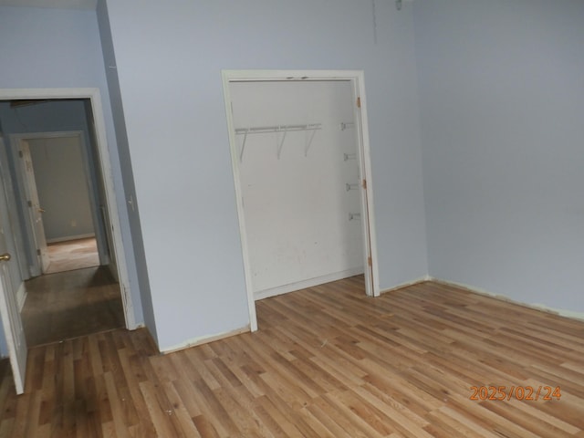 unfurnished bedroom with a closet and light wood-style floors