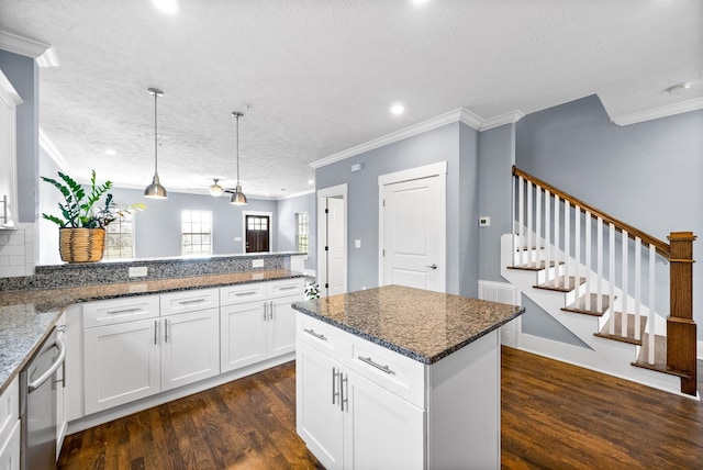 kitchen with hanging light fixtures, white cabinetry, dark wood-type flooring, and dark stone countertops