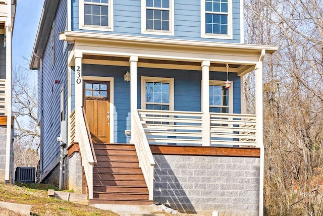 property entrance with a porch and central AC unit