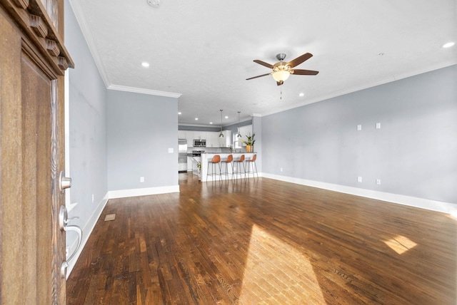 unfurnished living room with ornamental molding, dark wood-style flooring, a ceiling fan, and baseboards