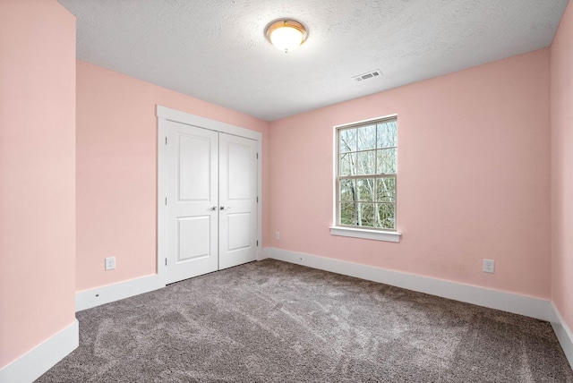 unfurnished bedroom with baseboards, visible vents, and carpet flooring