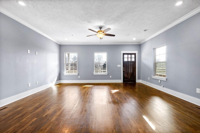 entryway with baseboards, dark wood finished floors, a textured ceiling, and ornamental molding