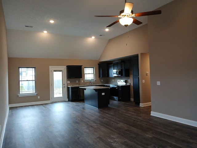 kitchen featuring visible vents, appliances with stainless steel finishes, open floor plan, a center island, and light countertops