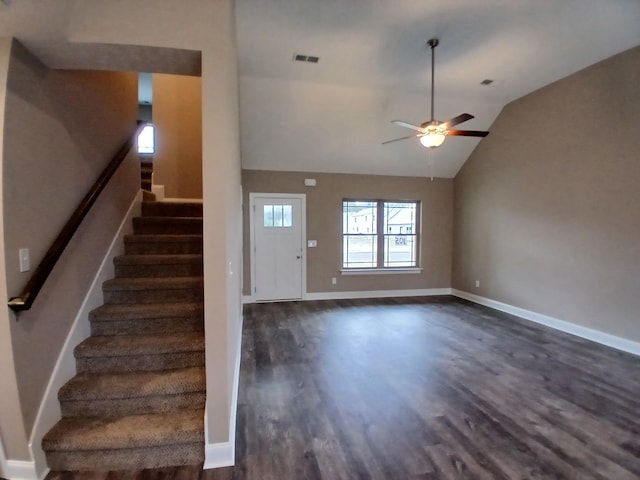 entrance foyer with dark wood-style floors, lofted ceiling, visible vents, stairway, and baseboards