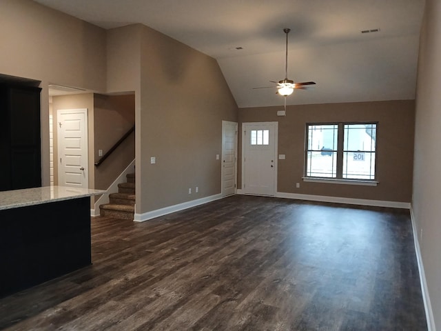 entryway with dark wood-style floors, lofted ceiling, visible vents, baseboards, and stairs