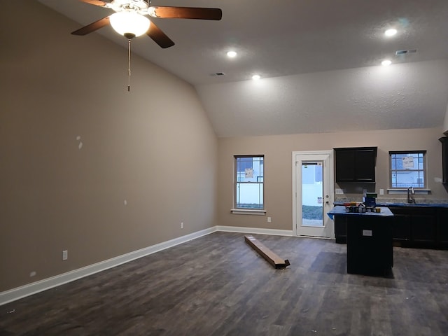 office space with vaulted ceiling, dark wood-style floors, visible vents, and baseboards