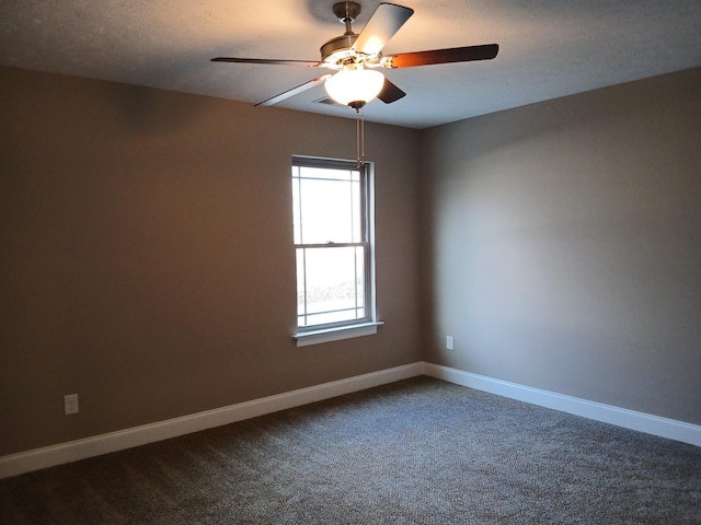 carpeted spare room featuring a textured ceiling, baseboards, and a ceiling fan