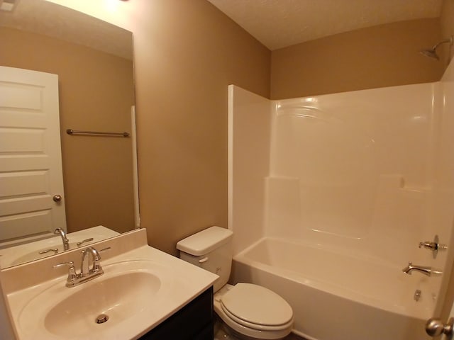 full bathroom featuring bathing tub / shower combination, toilet, and vanity