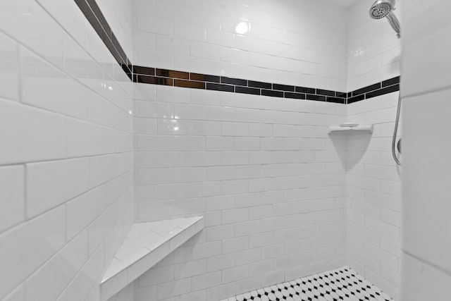 full bath featuring a tile shower