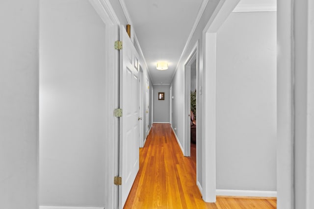 hallway with light wood finished floors and baseboards