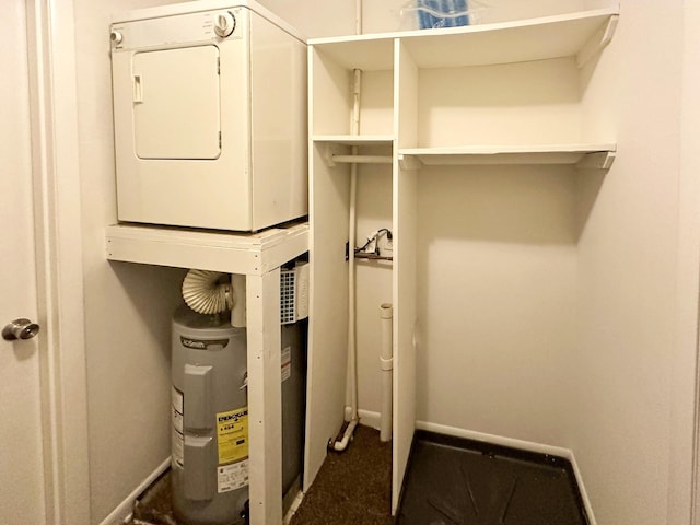 utility room with stacked washer and dryer and electric water heater