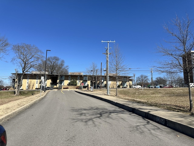 view of street featuring curbs, street lighting, and sidewalks