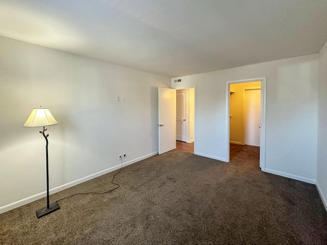 unfurnished bedroom featuring carpet floors, visible vents, and baseboards