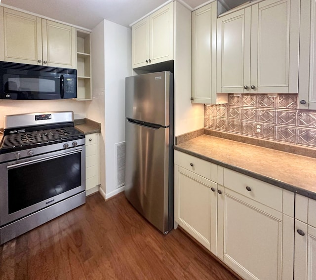 kitchen featuring dark wood finished floors, open shelves, visible vents, decorative backsplash, and appliances with stainless steel finishes