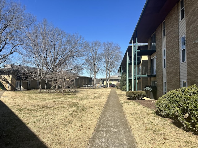 view of yard with a balcony