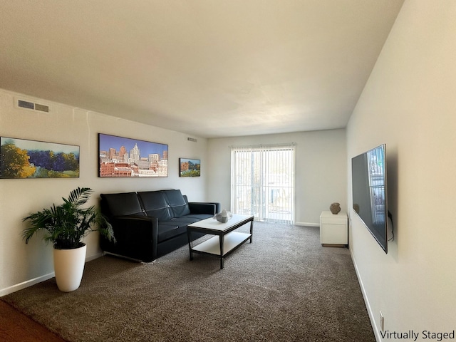 carpeted living area with baseboards and visible vents