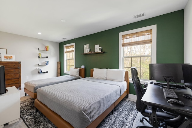 bedroom featuring visible vents and baseboards