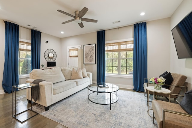 living area featuring recessed lighting, a healthy amount of sunlight, visible vents, and wood finished floors