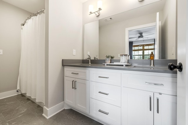 full bath with visible vents, a sink, baseboards, and double vanity