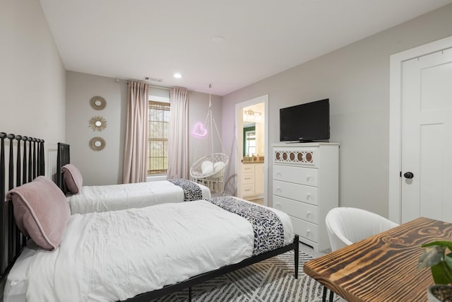 bedroom with ensuite bathroom and visible vents