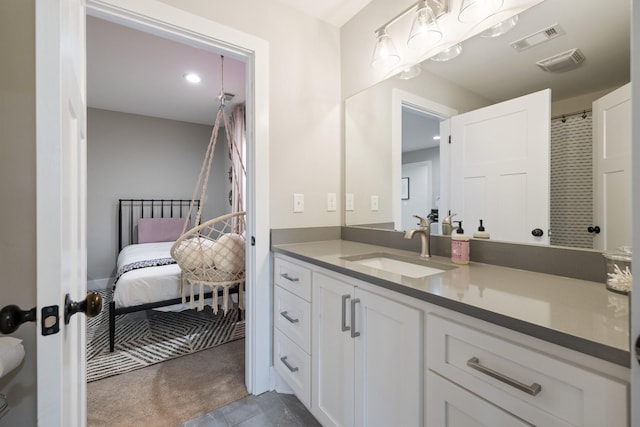 ensuite bathroom featuring ensuite bath, visible vents, and vanity