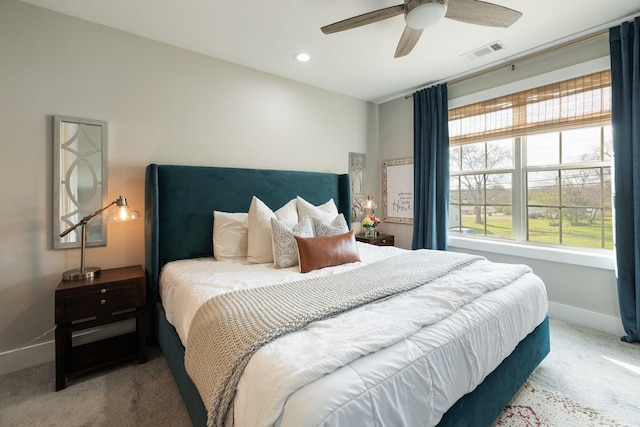 bedroom with multiple windows, carpet flooring, visible vents, and baseboards