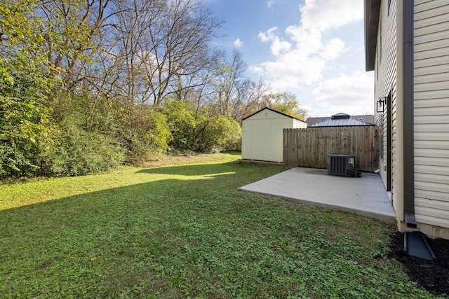 view of yard with cooling unit, a storage shed, an outdoor structure, fence, and a patio area