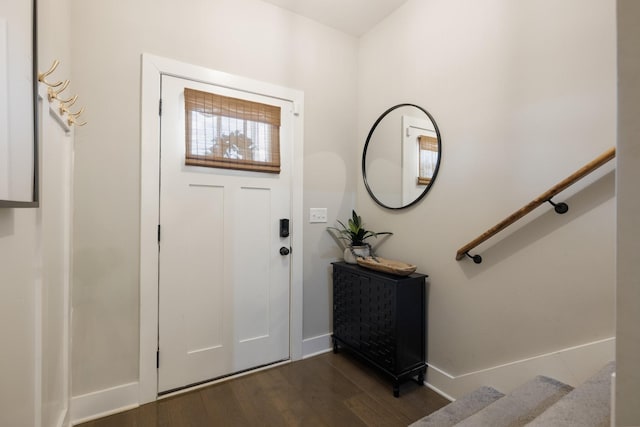 foyer with baseboards, stairway, and dark wood-type flooring