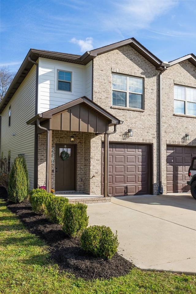 view of front of house featuring a garage, concrete driveway, and brick siding