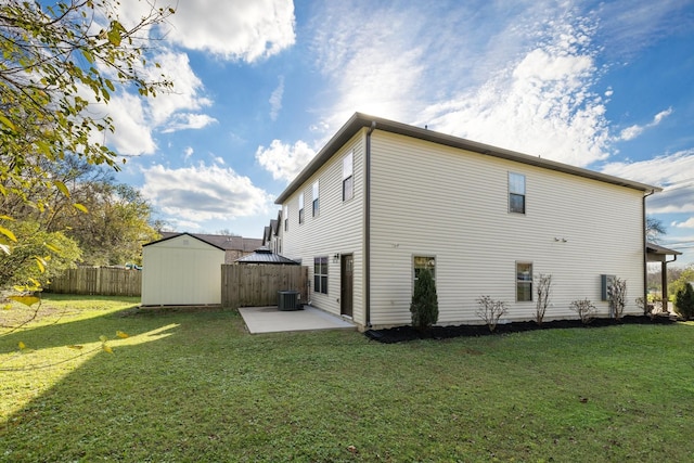 back of property with an outbuilding, a gazebo, a lawn, a shed, and a patio area