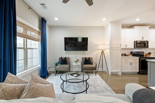 living area featuring a ceiling fan, recessed lighting, visible vents, and baseboards