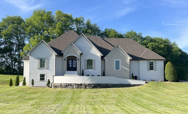 view of front facade featuring a front yard and french doors