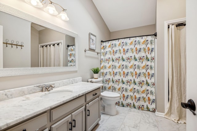 bathroom featuring toilet, marble finish floor, lofted ceiling, and vanity