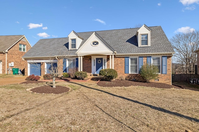 new england style home featuring crawl space, roof with shingles, a garage, and brick siding