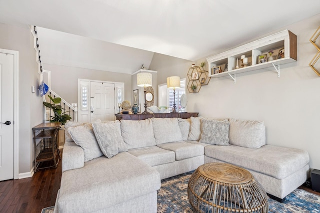 living area featuring vaulted ceiling, stairway, dark wood-style flooring, and baseboards