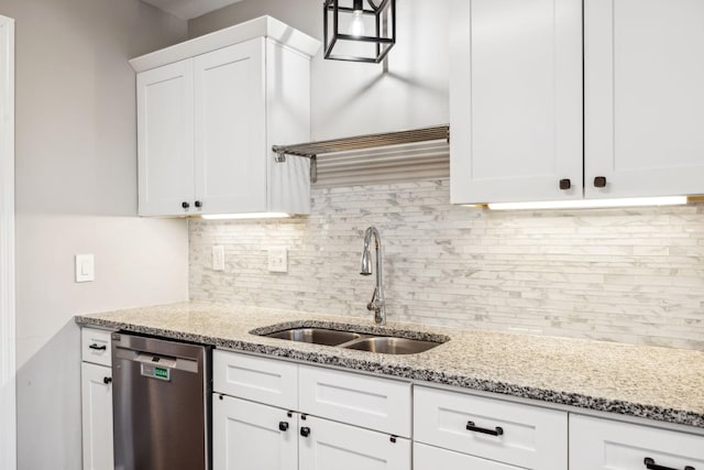 kitchen with backsplash, decorative light fixtures, stainless steel dishwasher, white cabinetry, and a sink