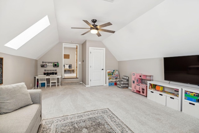 living room with carpet, vaulted ceiling with skylight, and ceiling fan