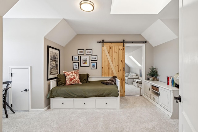 bedroom with vaulted ceiling, a barn door, light carpet, and baseboards