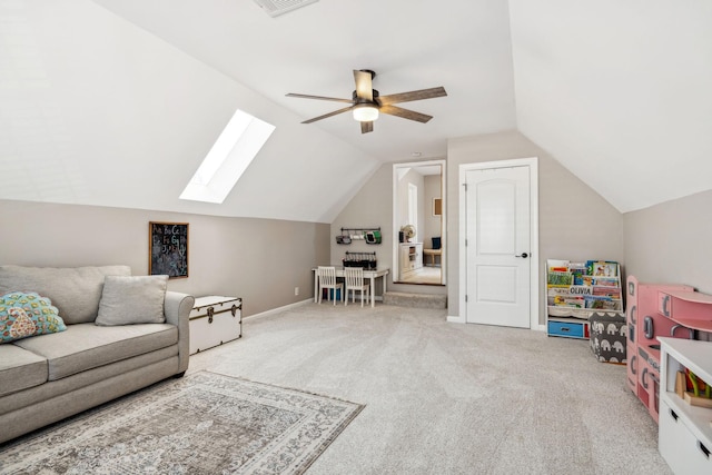 living area with lofted ceiling with skylight, ceiling fan, and carpet flooring