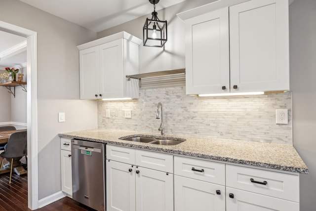 kitchen featuring a sink, white cabinets, stainless steel dishwasher, backsplash, and decorative light fixtures