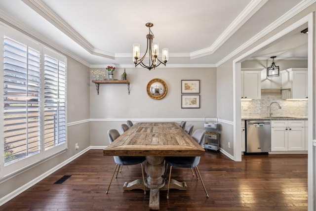 dining area featuring a tray ceiling, dark wood finished floors, visible vents, and baseboards