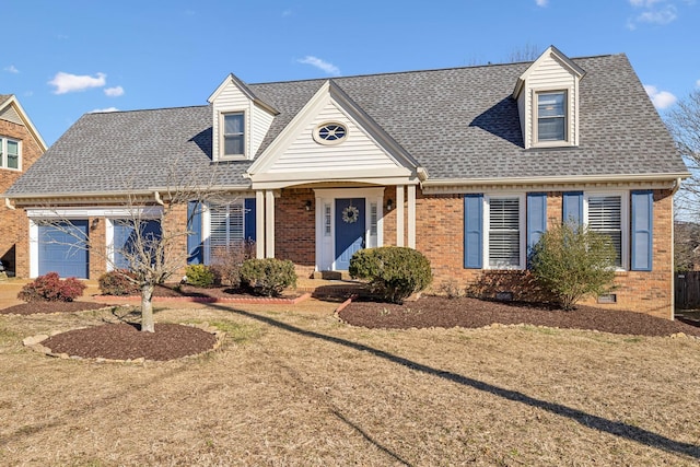 cape cod house with roof with shingles, brick siding, crawl space, and a front yard