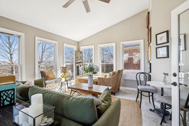 sunroom featuring lofted ceiling and a ceiling fan